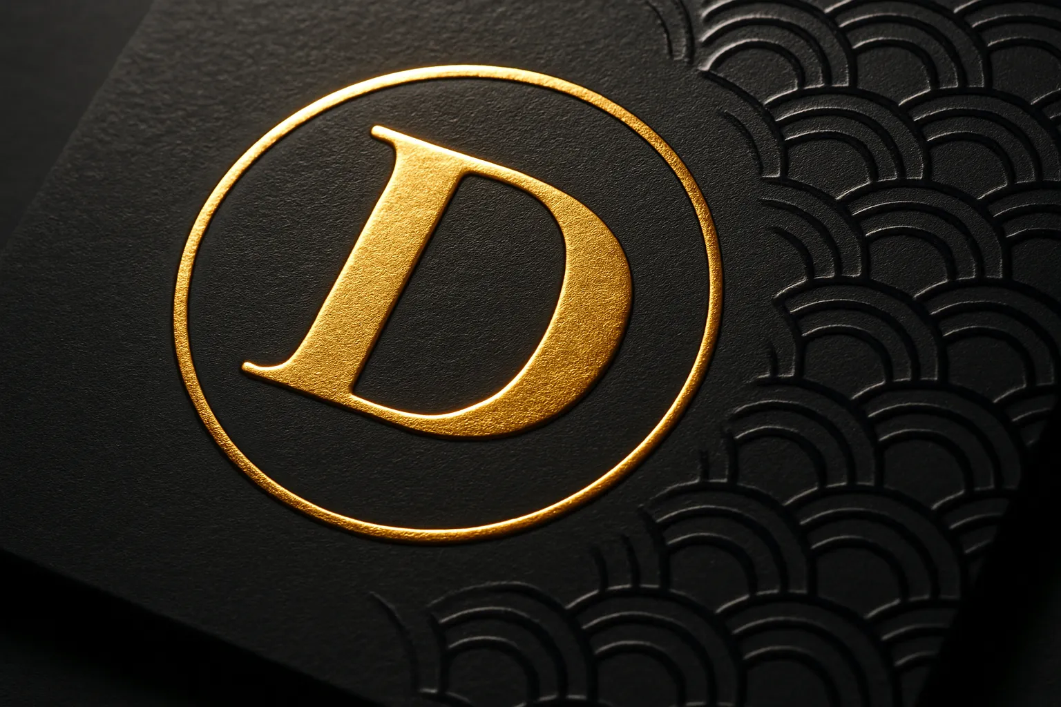 Macro of black carton highlighting gold foil, emboss relief and glossy spot UV pattern.
